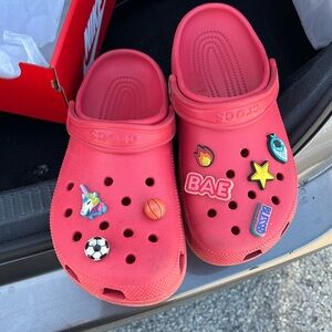 Worn and used Red crocs with gibets on them. As is! Wore them all the time!